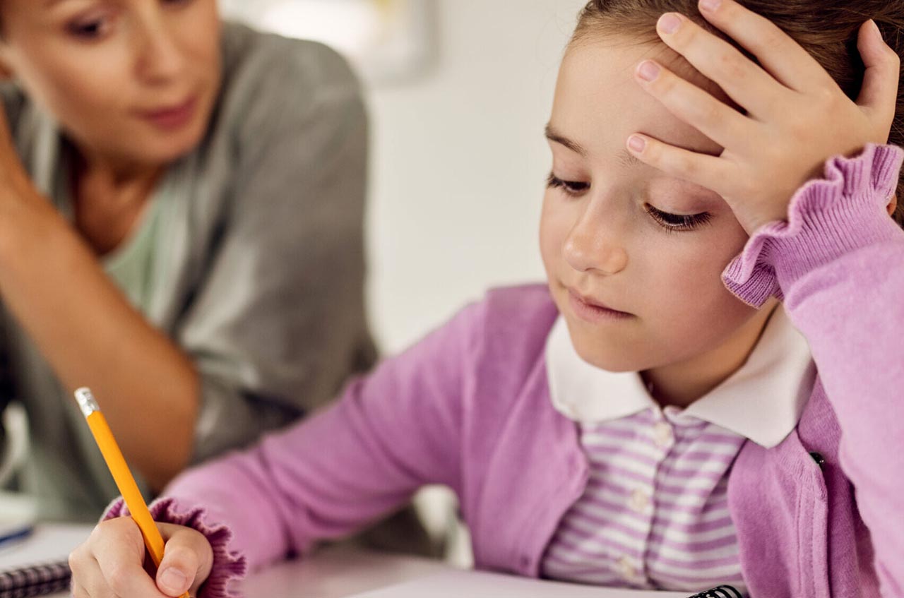 young girl with pencil and notebook, frustrated writing